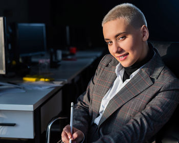 Portrait of smiling man sitting on table