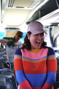 Cheerful woman standing in bus