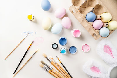 Woman preparing for easter. home decoration for holiday. coloring easter eggs with pastel paints