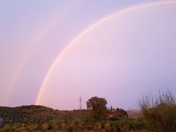 Scenic view of rainbow against sky during sunset