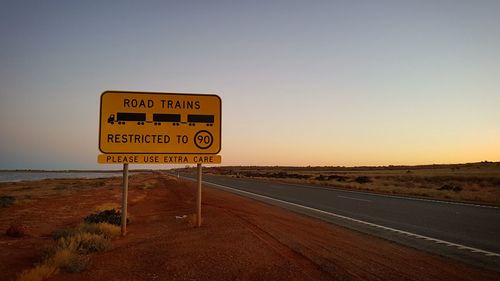 Road sign against clear sky