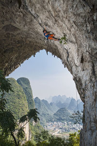 Man climbing on moon hill in yangshuo, a climbing mekka in china