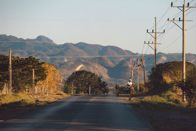 Road by mountain against clear sky