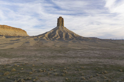 Erosion cuts deep lines in the earth surround the chimney rock m