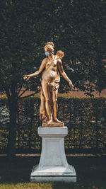 Statue against trees in park