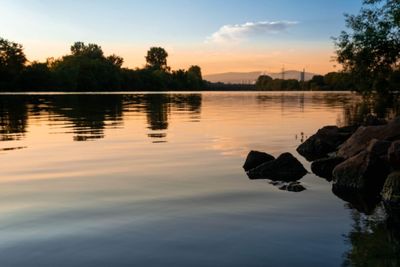 Scenic view of lake against sky during sunset