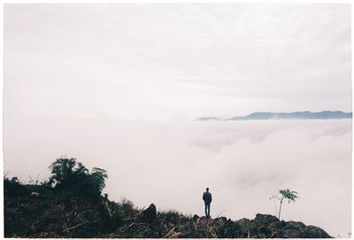 Man standing on land against sky