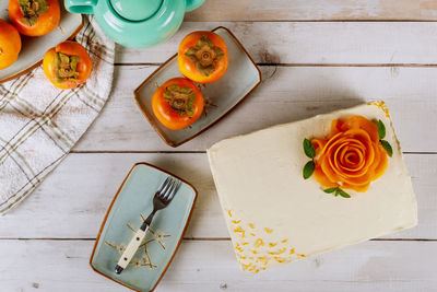 High angle view of orange roses on table