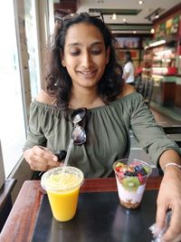 Smiling woman holding drink