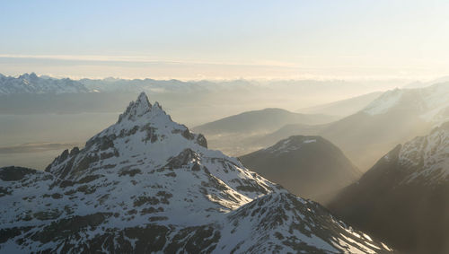 Scenic view of snowcapped mountains against sky during sunset