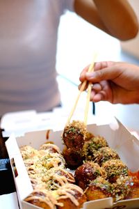 Close-up of person holding food in restaurant