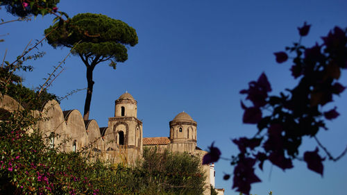 Low angle view of historical building against blue sky at ravello