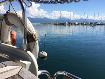 Boats moored in sea against sky