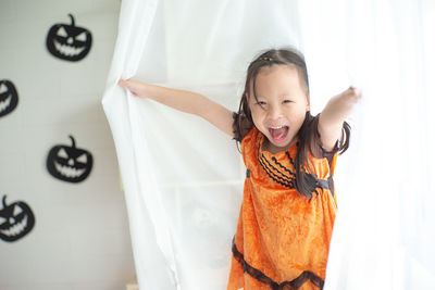 Closeup portrait of little girl playing in the room decorated in halloween festival