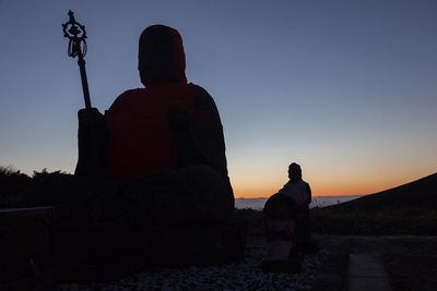 Silhouette of woman at sunset