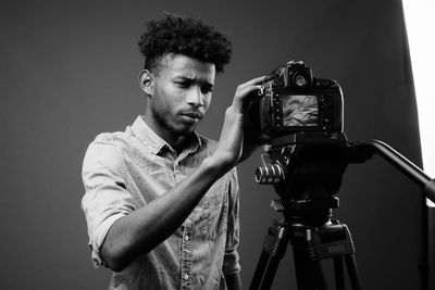 Portrait of young man photographing