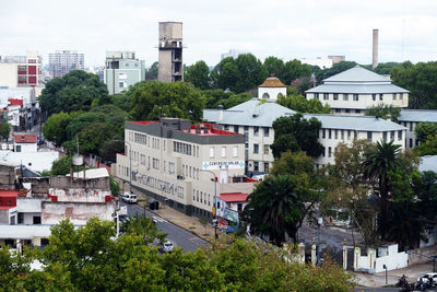 High angle view of buildings and trees against sky