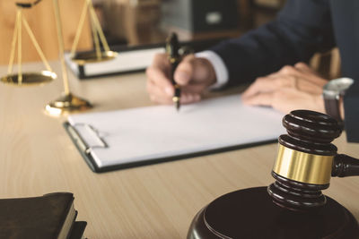 Close-up of man sitting on table