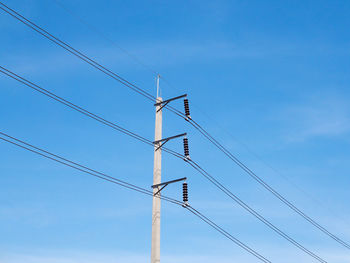 Low angle view of electricity pylon against sky