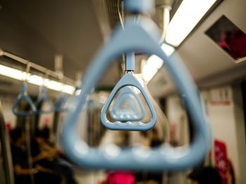 Close-up of electric lights hanging from ceiling