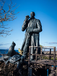 Low angle view of statue against blue sky