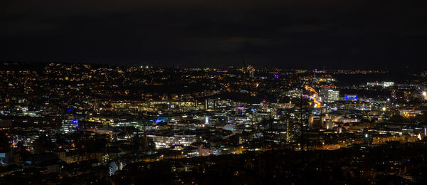 High angle view of city lit up at night