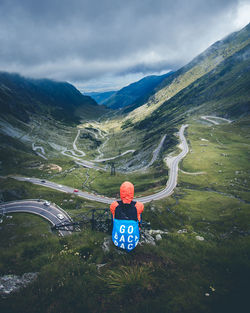 Rear view of man in mountains against sky