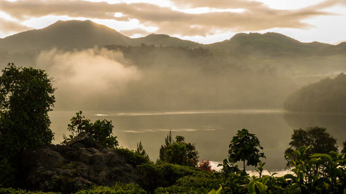 Scenic view of lake and mountains against sky