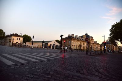 Town against sky at sunset