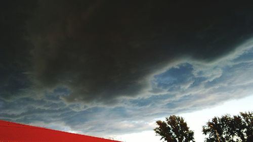 Low angle view of building against cloudy sky