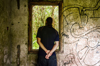 Full length of man standing against tree