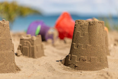 Close-up of sand castles on beach