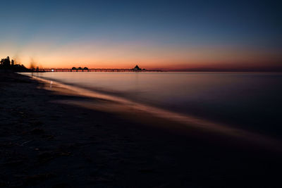 Scenic view of beach against sky during sunset