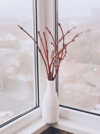 Close-up of vase on window sill