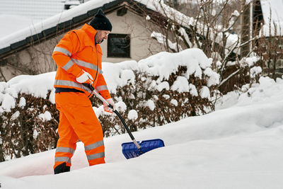 Low angle view of man working on snow