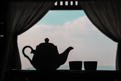 Silhouette of man on table against sky