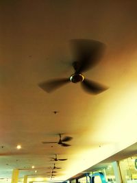 Low angle view of electric lamp hanging on ceiling