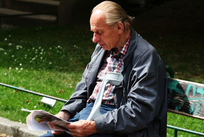 Man using mobile phone while sitting on seat