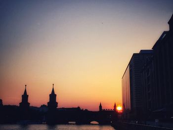 Silhouette of buildings against sky during sunset