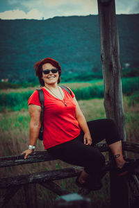 Portrait of smiling woman sitting outdoors