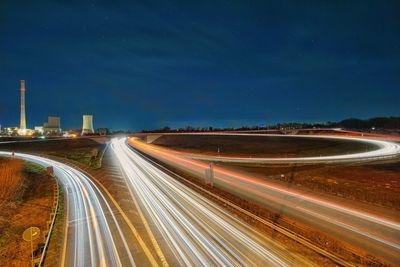 High angle view of light trails on road at night