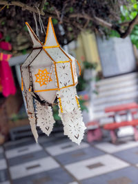Close-up of lantern hanging from tree