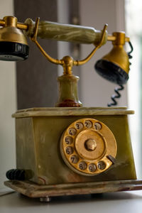 Close-up of rotary phone on table