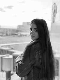 Portrait of young woman standing outdoors