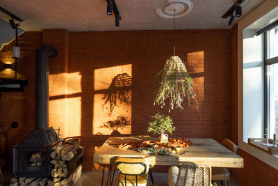 Potted plants on table by window at home