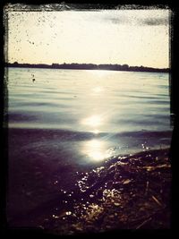 Scenic view of lake at sunset