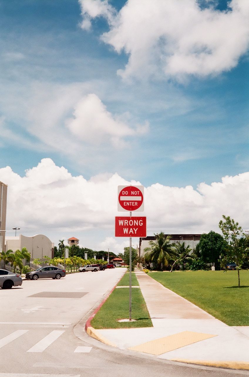 cloud - sky, sky, text, communication, road, day, road sign, transportation, guidance, no people, architecture, built structure, outdoors, tree