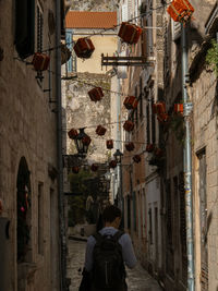 Rear view of woman walking on street