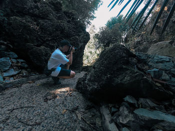 Rear view of young man on rock