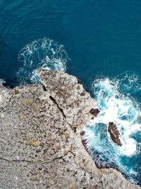 High angle view of rock in sea